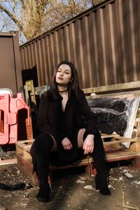 Model Sat on pallets in a rustic urban location