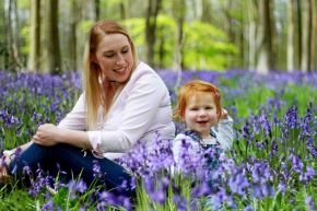 Mother and daughter sitting in the bluebells