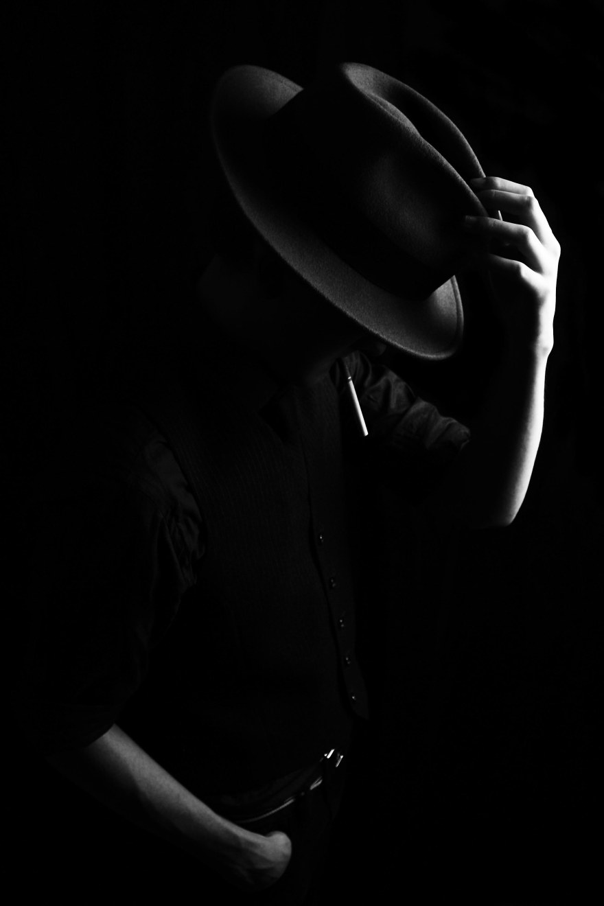 Gangster style portrait of male model with fedora in black and white